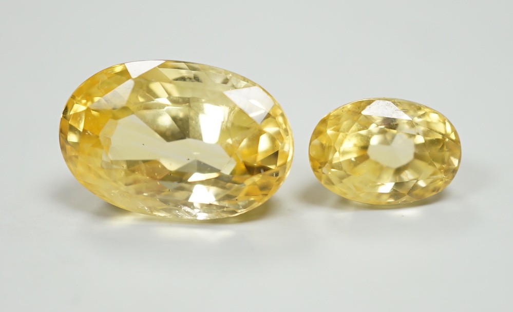 Two oval cut unmounted yellow sapphires, weighing approximately 13.00ct and 4.60ct.